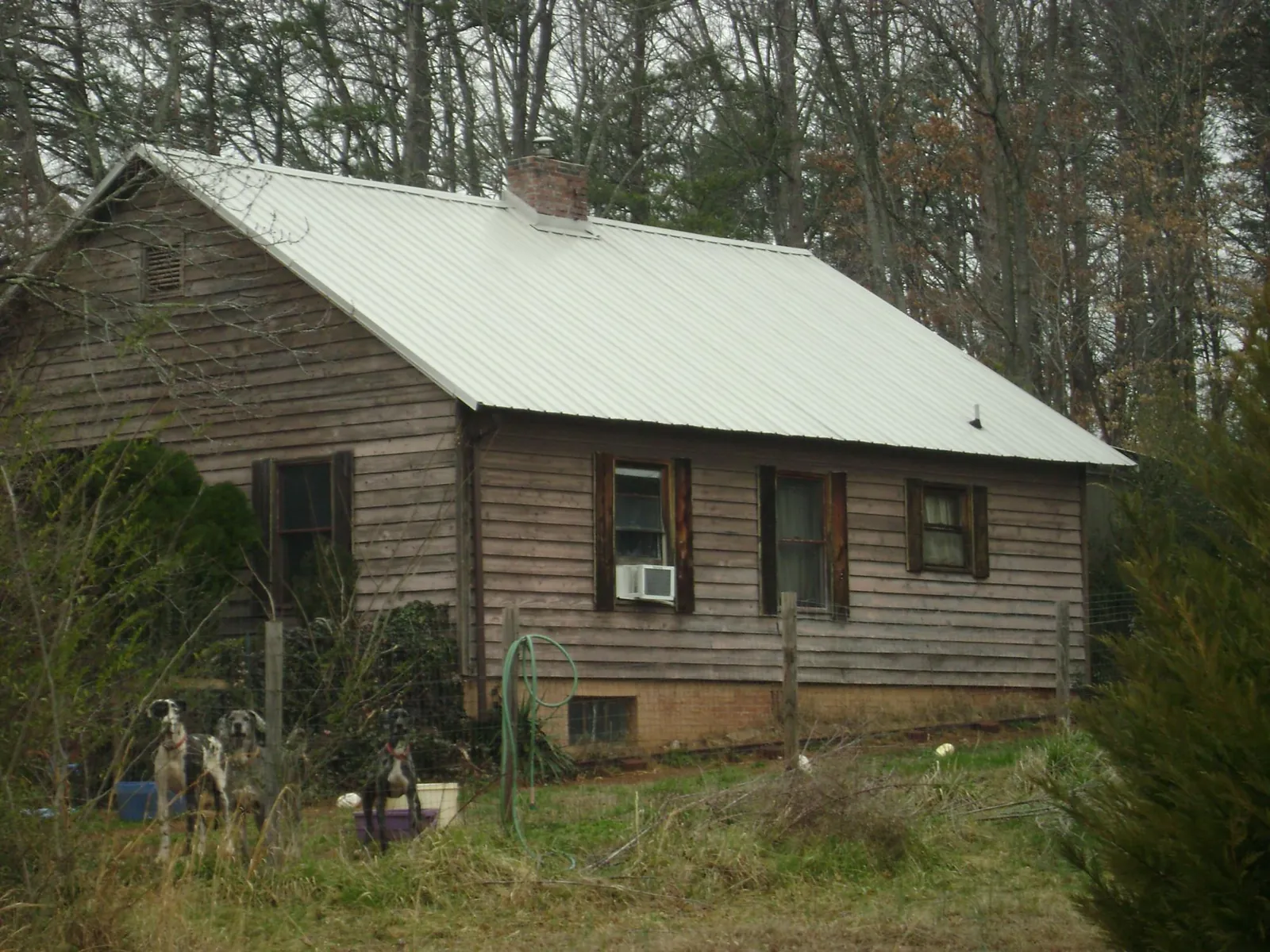 White metal roof on an old wood sided farmhouse, from a Metal Roof Installation job in Mcminnville